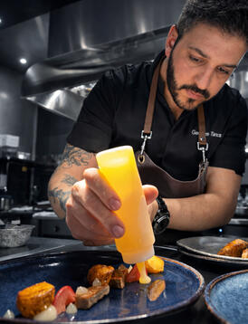 Chef finishing a plate during service